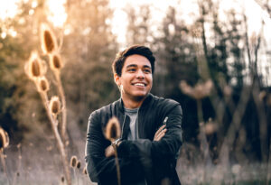 Joyful male in a field at sunset